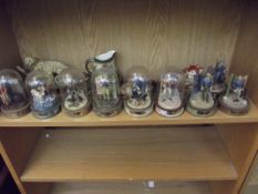 Set of John Wayne figures, some with glass domes,