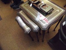 Nest of three glazed and leather inset tables