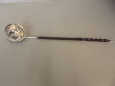 Georgian toddy ladle possibly silver, baleen whale twist handle, the bowl inset with Queen Anne coin