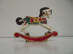 Cast metal door stop in the form of a rocking hors