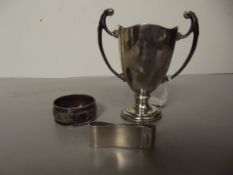 Silver trophy, silver note holder and silver napki