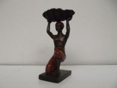 Bronze native boy holding shell