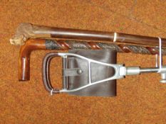 Two walking sticks together with a shooting stick