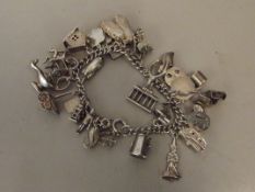 Silver charm bracelet, approx 30 charms