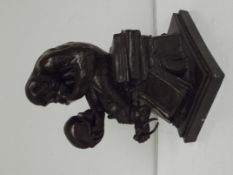 Bronzed resin monkey studying a skull, in the styl