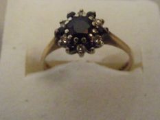 9 ct gold cluster ring with red centre stone size