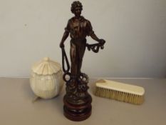 Figure of a man and two others