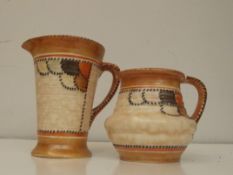 Two Crown Ducal jugs in the Charlotte Reed style,