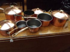 Group of copper pans, polished and lacquered, some