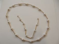 Yellow metal necklace with matching bracelet