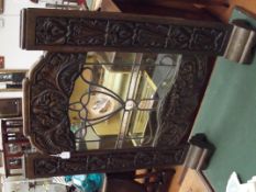 Carved wood fire screen with central leaded glass
