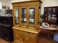 Large light wood illuminating display cabinet
