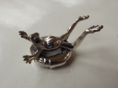 Silver stamped frog in life ring