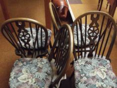 Set of four wheel-back dining chairs