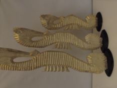 Three painted graduating seahorse figures, largest