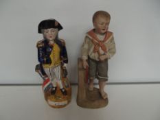 Bisque figure of a boy together with a Nelson Toby