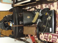 Two pairs of field glasses together with camera an