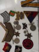 Group of military medals and cloth badges