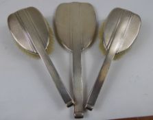 A Silver Dressing Table Set, comprising mirror and two hair brushes, Birmingham hallmark, dated