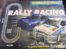 A Scaletrix Race Track with Two Suburu Vehicles and track in the original box.