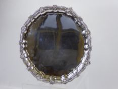 A Silver Salver. The salver having a scalloped pie crust ribbon and shell design edge,