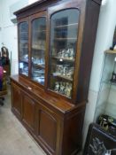 A Late Victorian Library Bookcase, three arched glazed cupboards revealing three shelves, with three