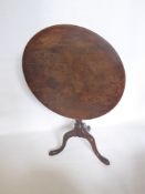 An Oak Georgian Tilt Top Wine Table, raised on turned column and splayed pad foot.