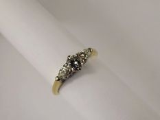 A Lady's 18 ct Yellow and White Gold Three Stone Diamond Ring, the central dia flanked by two tear
