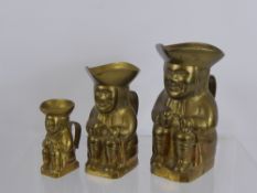 Three Graduated Miniature Brass Toby Jugs, 1 x 6 cms, 1 x 12 cms and 1 x 14 cms.