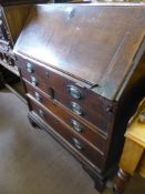 A Georgian Oak Drop Front Writing Bureau, with two short and two graduated long drawers, fitted
