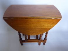A Light Oak Barley Twist Drop Leaf Table.