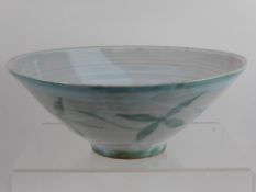 A Studio Pottery Fruit Bowl, green glaze floral decoration, monogram to base AB.