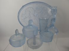 A Light Blue Glass Dressing Table Set, comprising candle sticks, two small trinket dishes, cotton