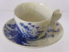 A Early 20th Century Japanese Blue and White Tea Cup and Saucer, hand painted with partridge amongst