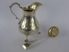 A Victorian Silver Cream Jug, London hallmark dd 1859, mm RH, together with a sugar sifter, London