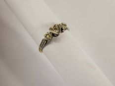 A Lady's 18 ct Yellow Gold and Platinum Three Stone Diamond Ring, central heart shape setting set