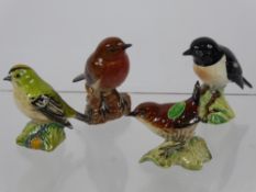 A Miscellaneous Collection of Beswick Birds, including wren, robin, goldcrest and magpie. (4)