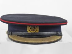 An Edward VII Officers Cap and Gilt Badge, together with a white dust cover.