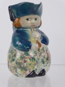 An Antique Staffordshire Character Jug, depicting a small figure smoking a pipe, approx 14 cms,