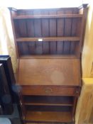 An Arts & Crafts Style Book Case Desk. The desk having three shelves with drop-down writing slope