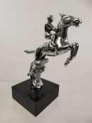 A Chrome-Plated Bonnet Ornament, in the form of a jump jockey, stamped copyright, raised on a square