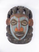 An Antique West African Fertility Mask, the mask intricately worked with black, white, blue and