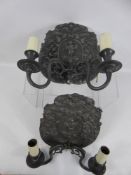 A Pair of Antique Twin Branch Light Sconces, lead effect decorated with cherubs and foliage.