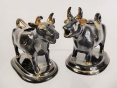 Two Black Ceramic Cow Creamers.