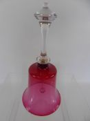 A Victorian Cut Glass Cranberry Bell, approx 27 cms.