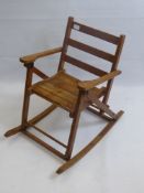 An Antique Child's Nursery Rocking Chair.