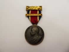 A Good Conduct Medal dated 1913-14, together with two books A Copy of 