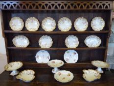 A Part Limoges Dinner Service, including two compote, eight plates and two serving dishes,