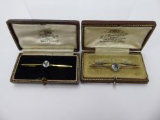 An Antique 9 ct Gold Aquamarine Bar Brooch, aqua 8 x 6 mm, together with another 9 ct blue stone