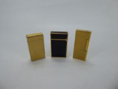 Gentleman's Lot, Du Pont Black Enamel Lighter with two Colibri London Lighters. (3)